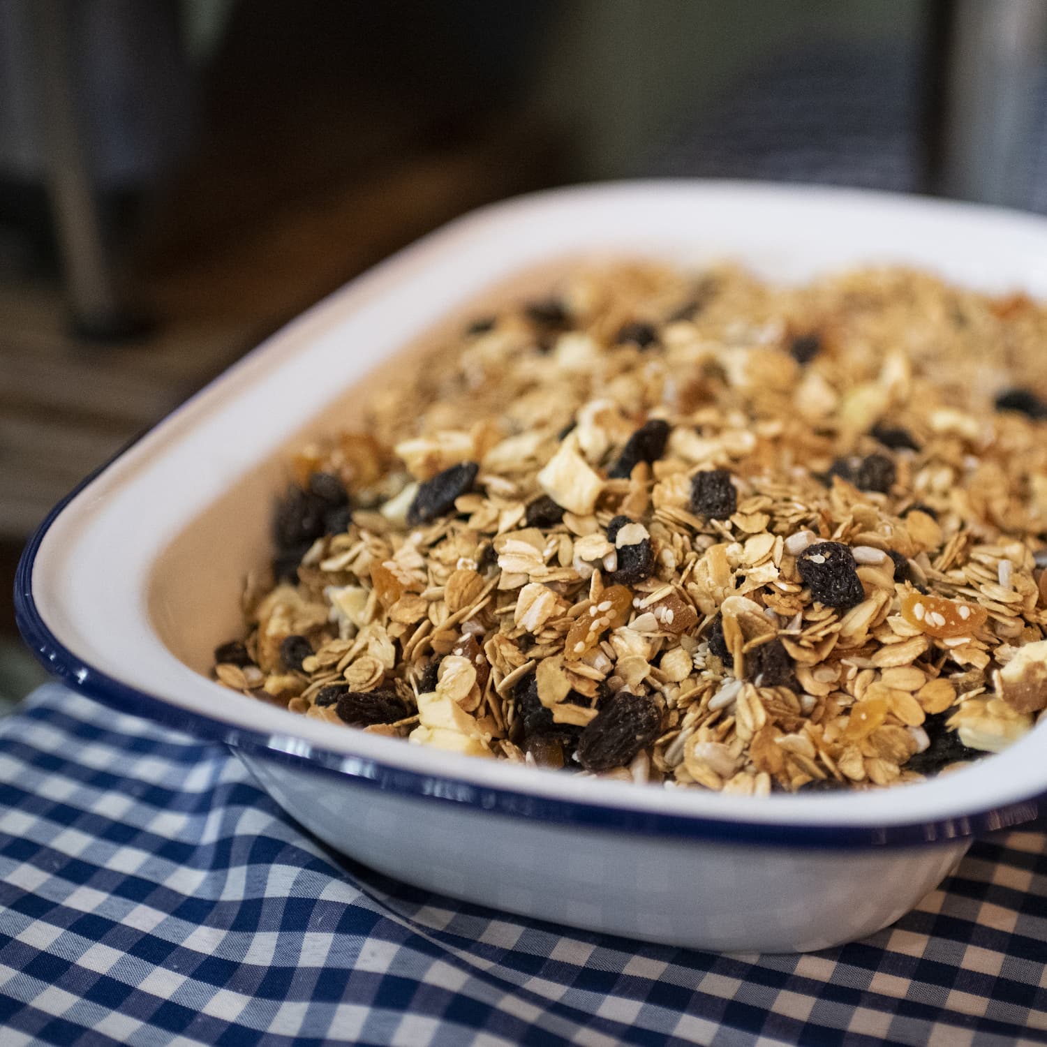 Home-made toasted muesli in white enamel bowl