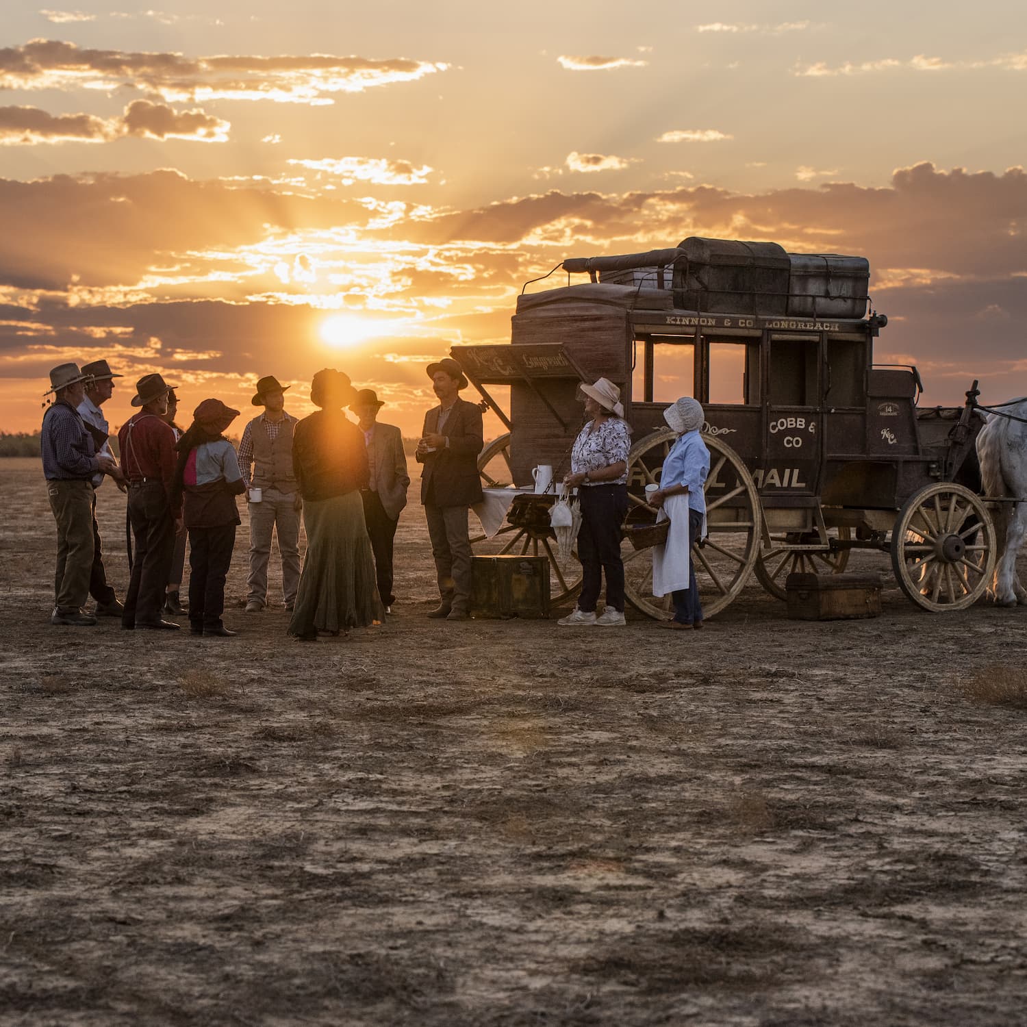 As sun sets behind the Stagecoach, 10 tour guests gather and listen to stories