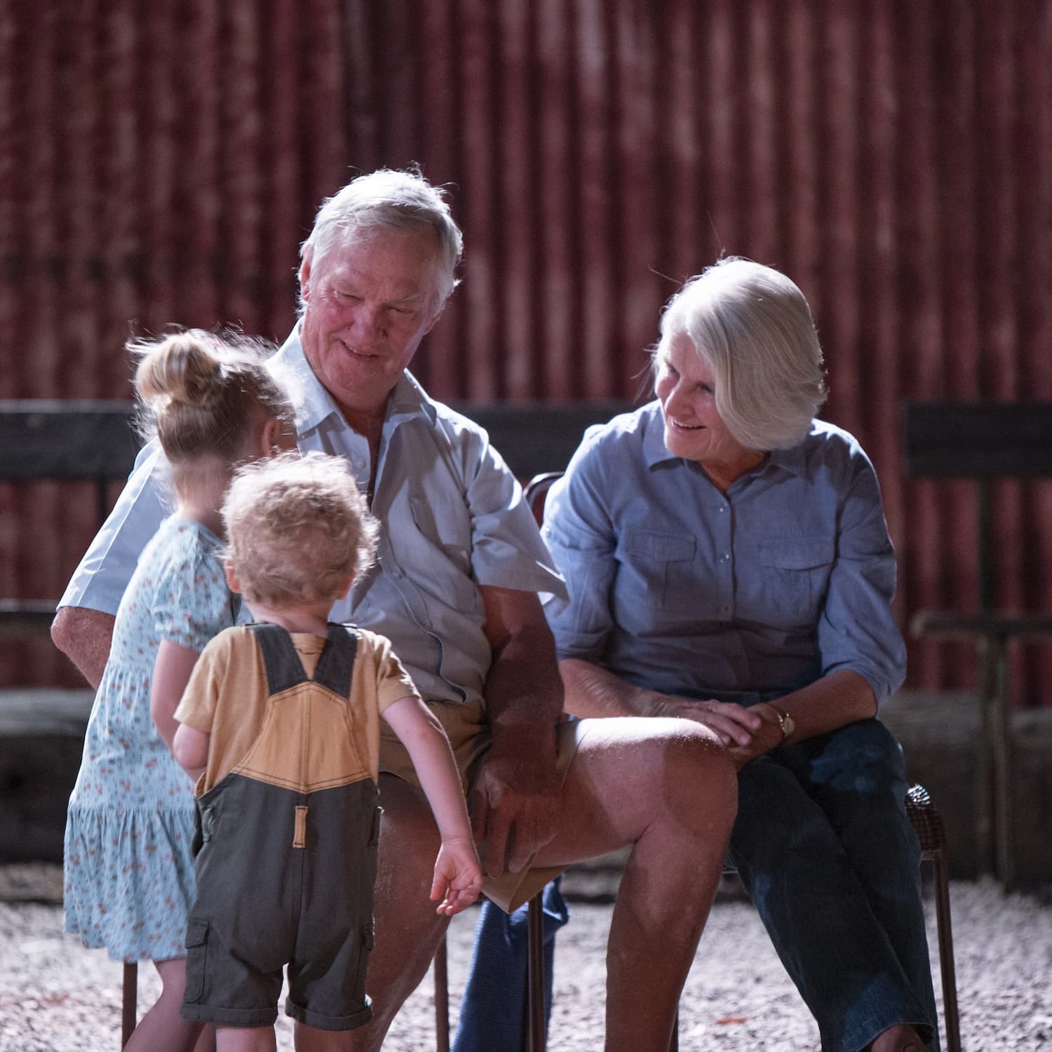 Grandparents chatting with two children under five years