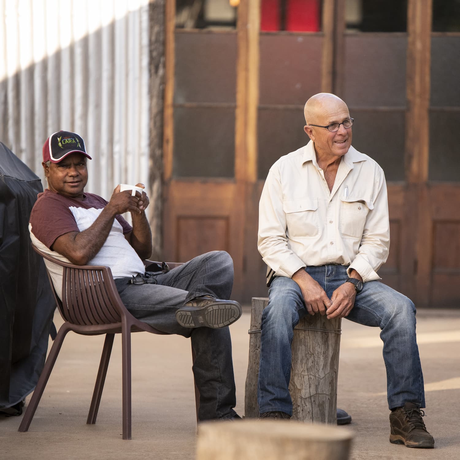 Two men relaxing on chairs at The Staging Post