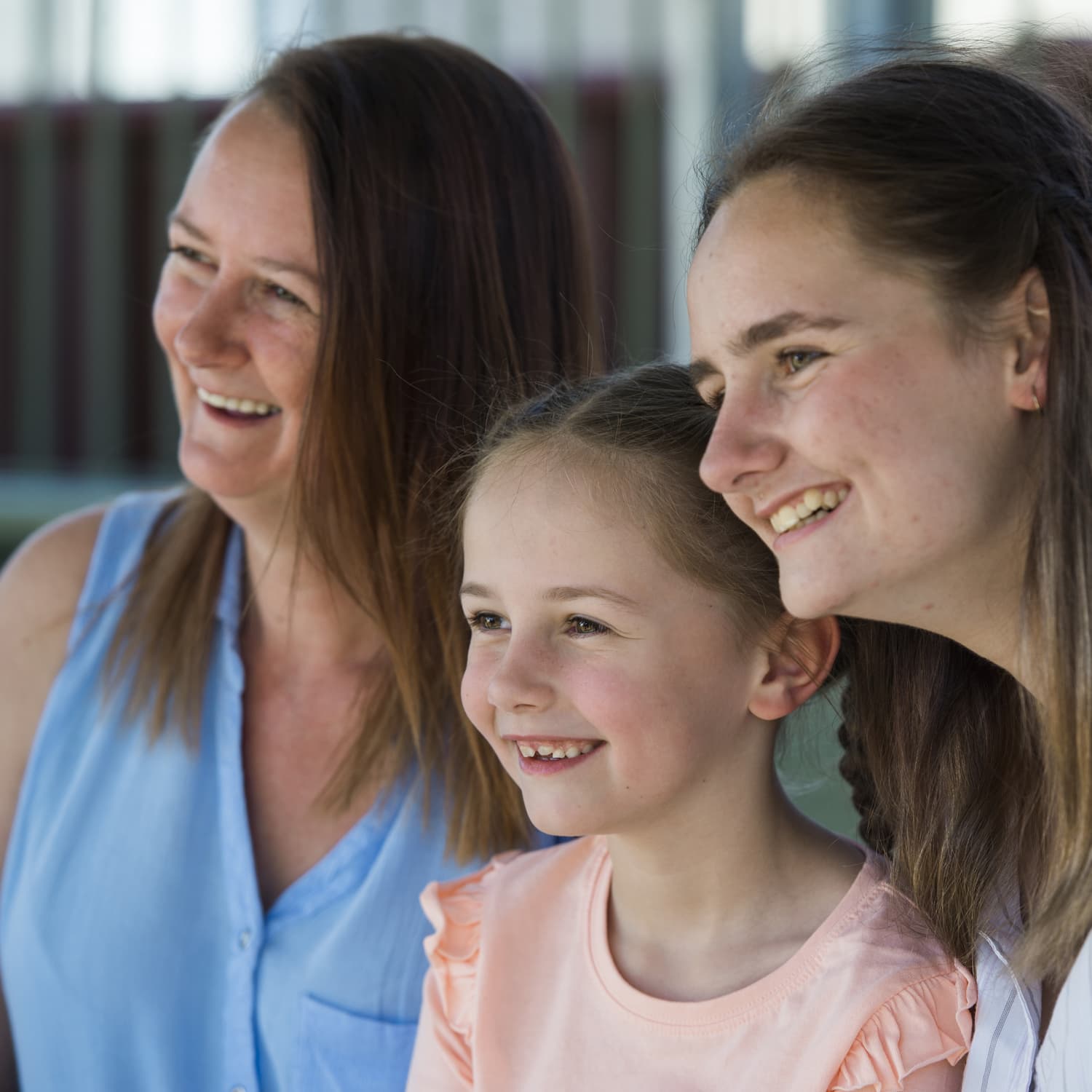 Mother and two daughters smiling