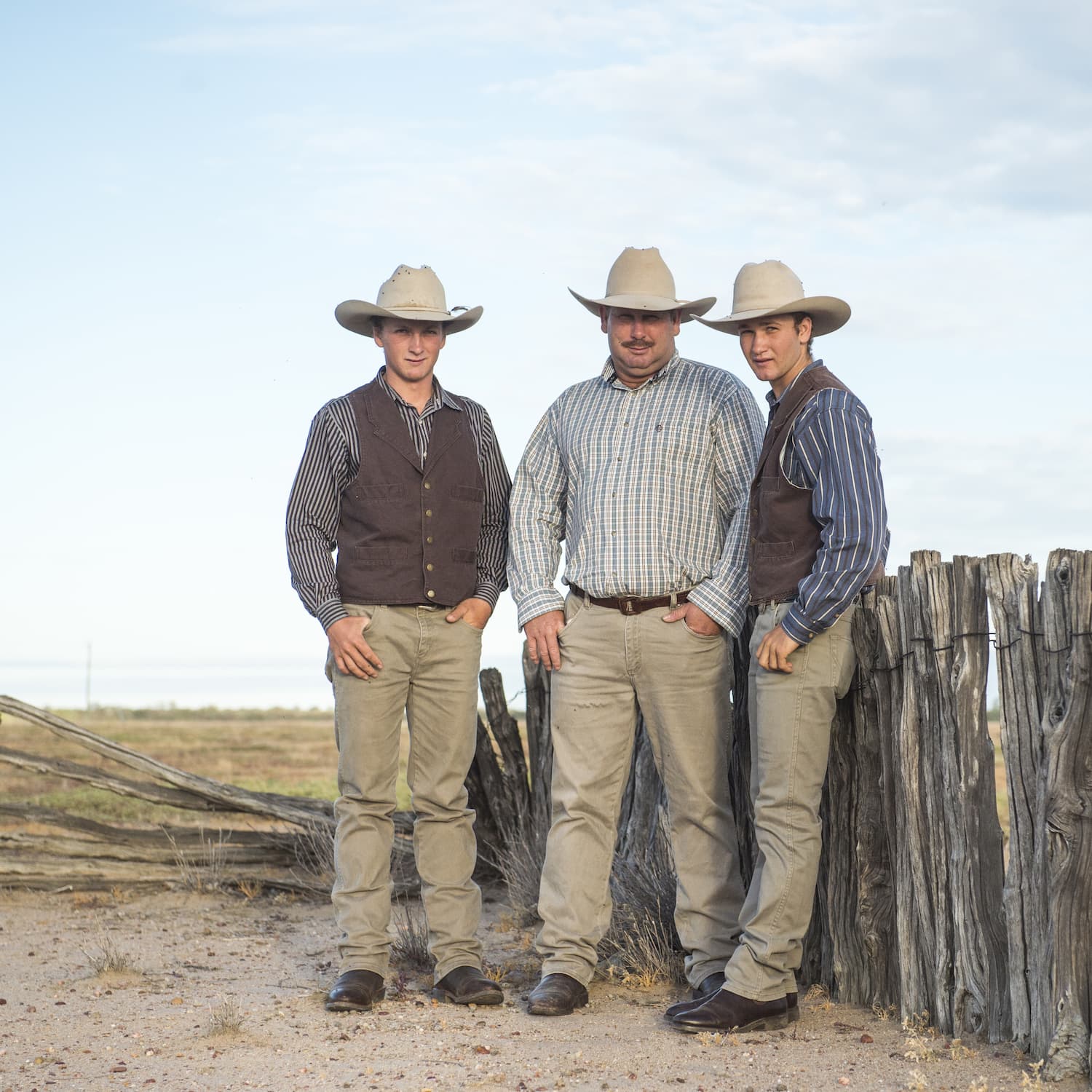 Jeremy, Richard and Lane Kinnon leaning against an old timber fence