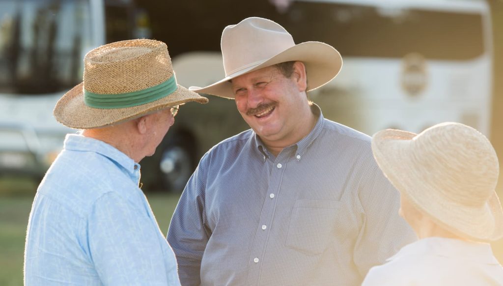 Richard Kinnon smiling and chatting with elderly man