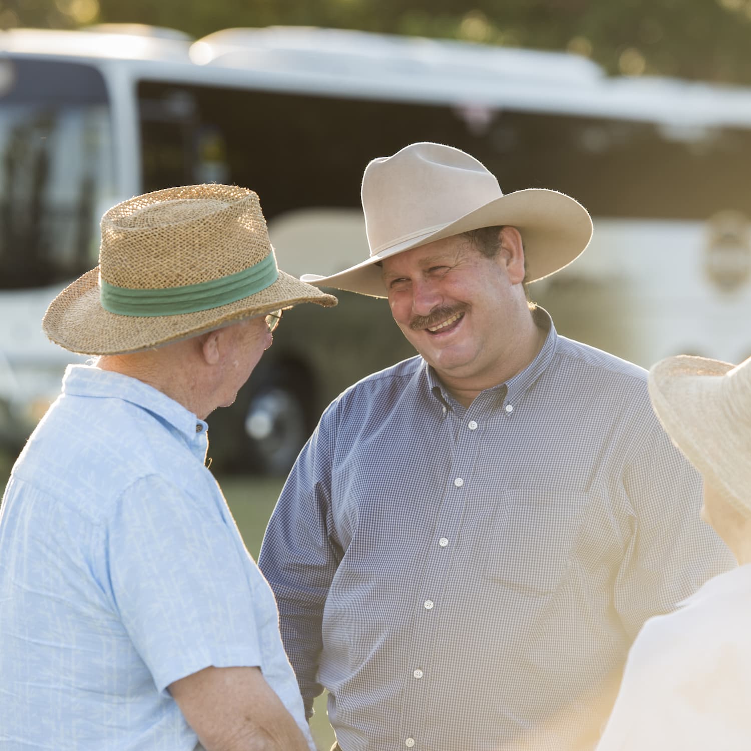 Richard Kinnon smiling and chatting with elderly man