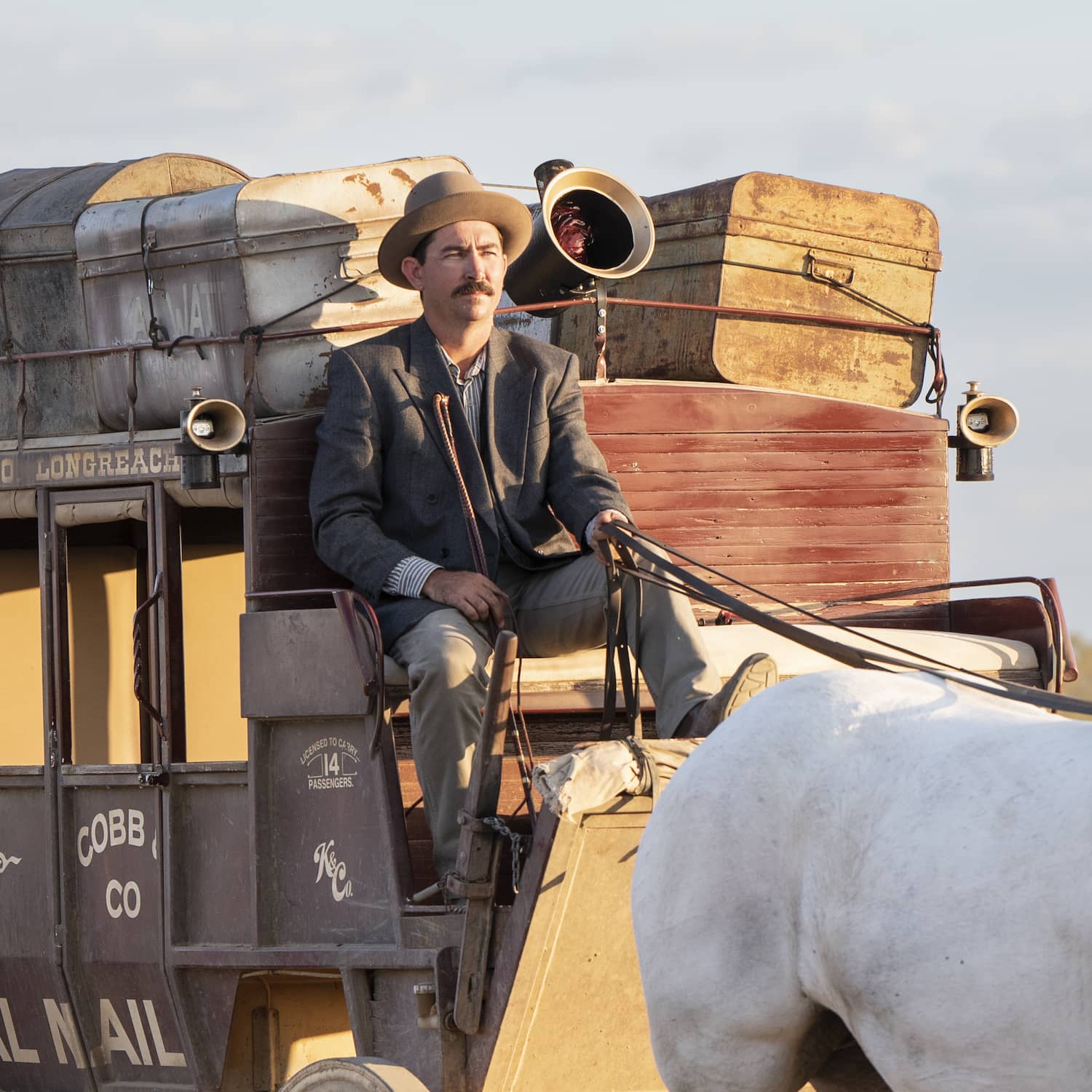 Cobb and Co stagecoach driver sitting on stagecoach holding the reins
