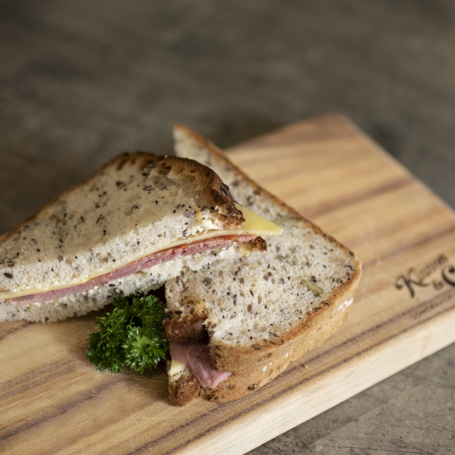 Corned meat and cheese sandwich on timber board