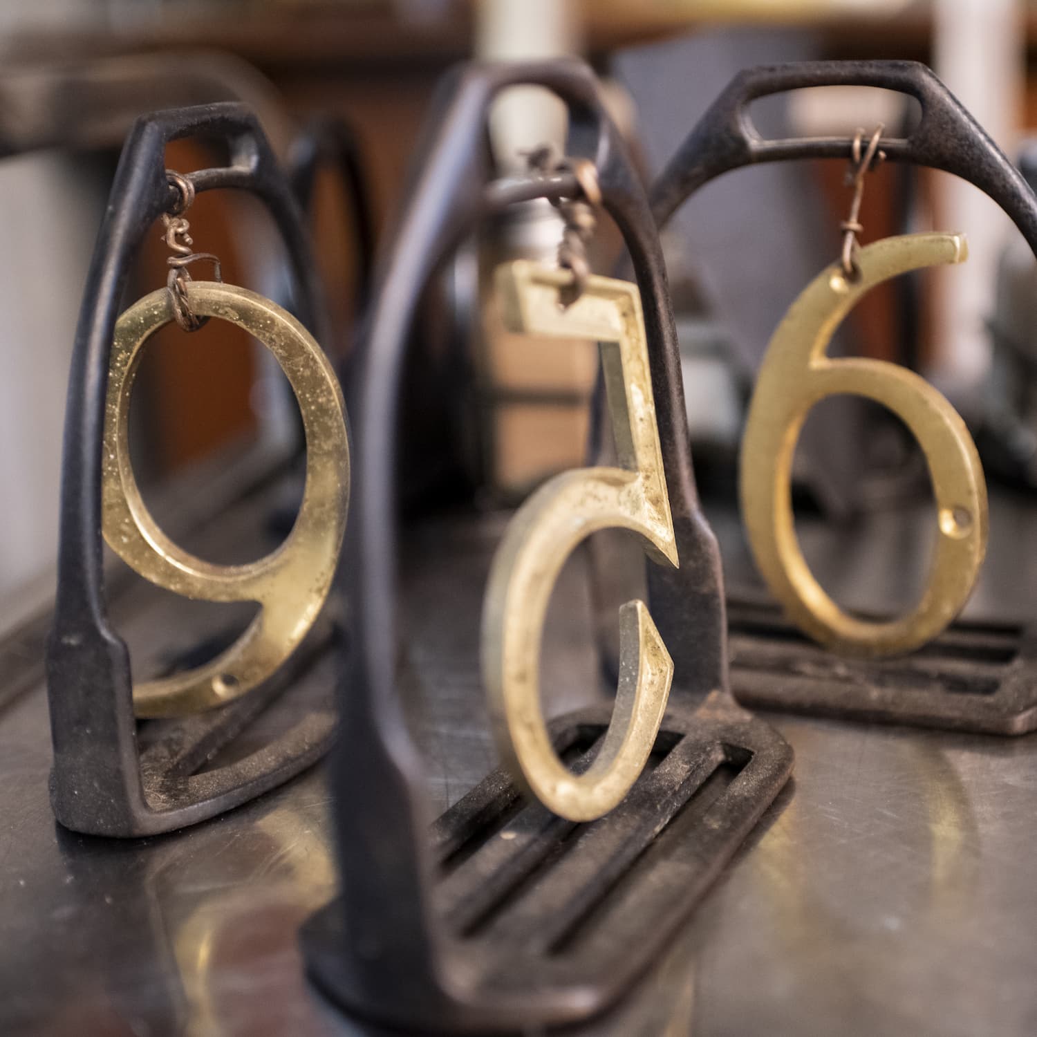 Metal horse shoe style table numbers on table