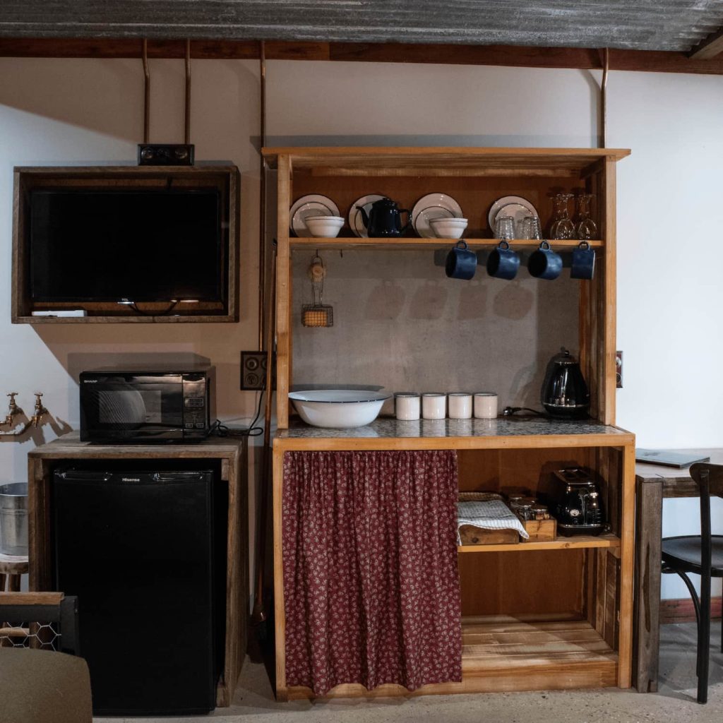 The Stables deluxe room hutch with TV and microwave