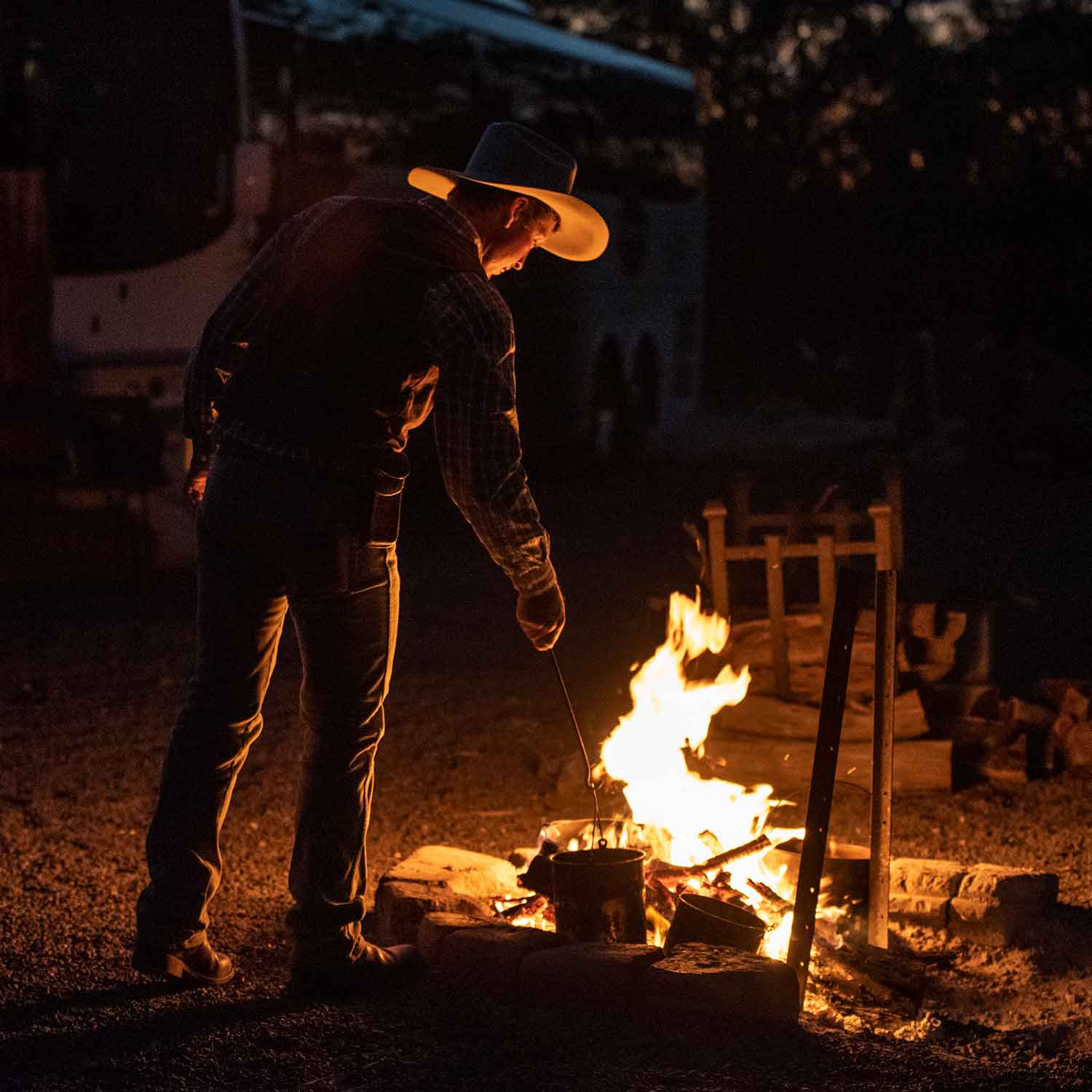 Stockman making billy tea over a campfire