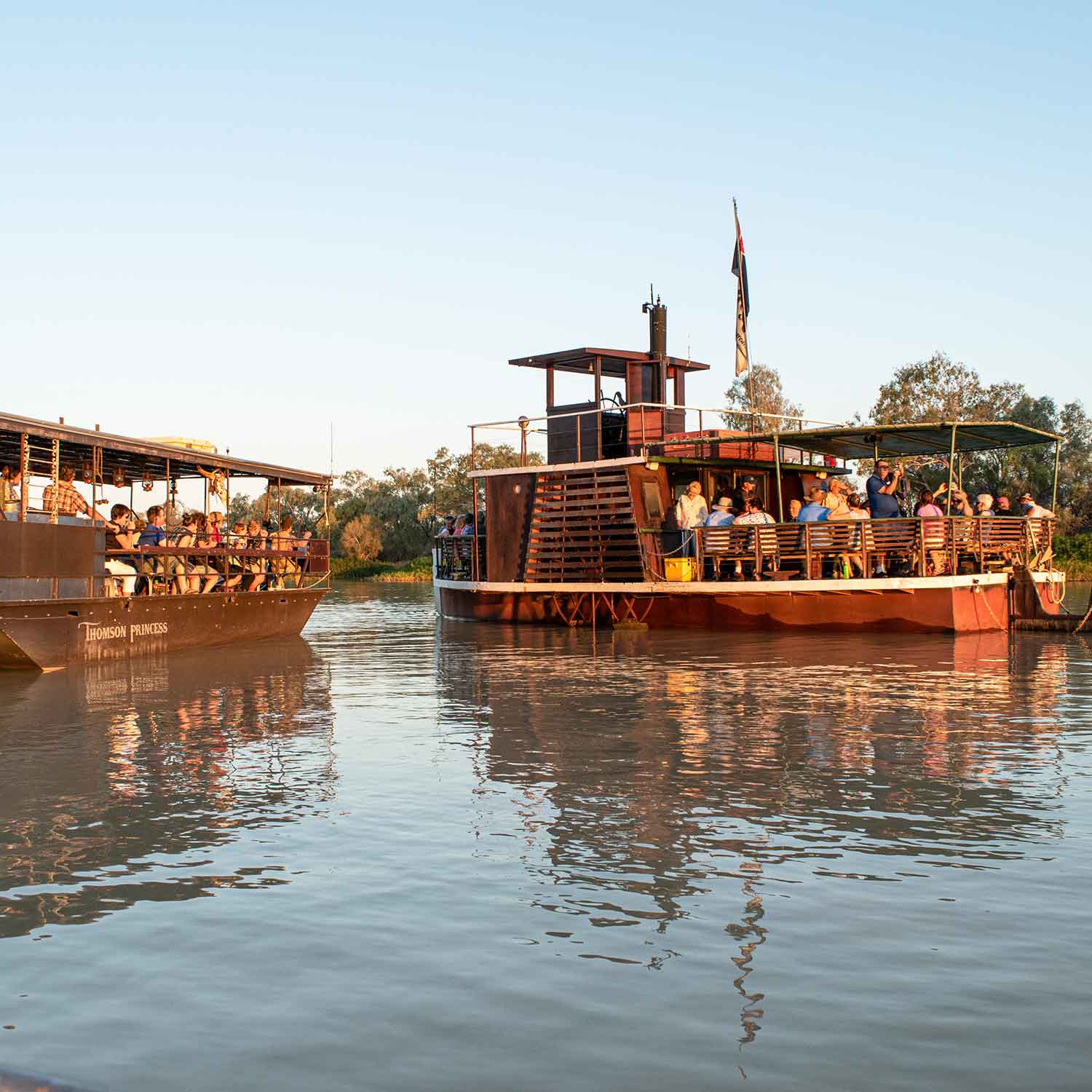 Two boats idling on the Thomson River