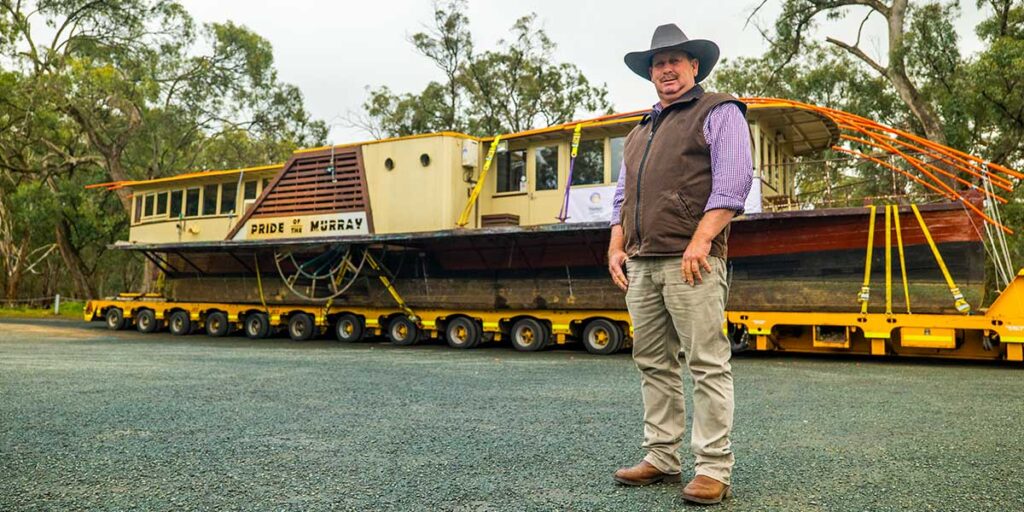 Pride of the Murray paddlewheeler loaded onto a low-loader ready. Richard Kinnon standing in foreground