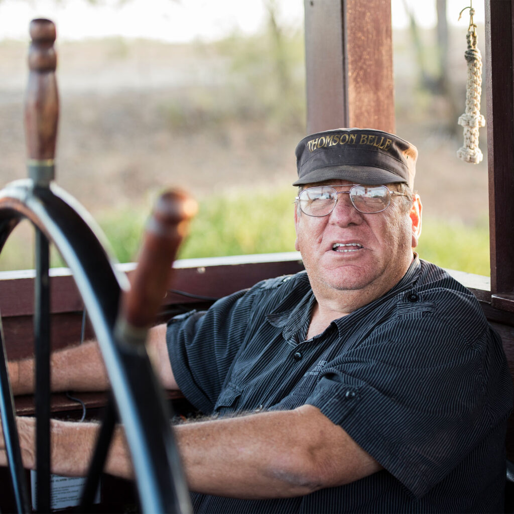 A man sitting at the wheel of the Thomson Belle