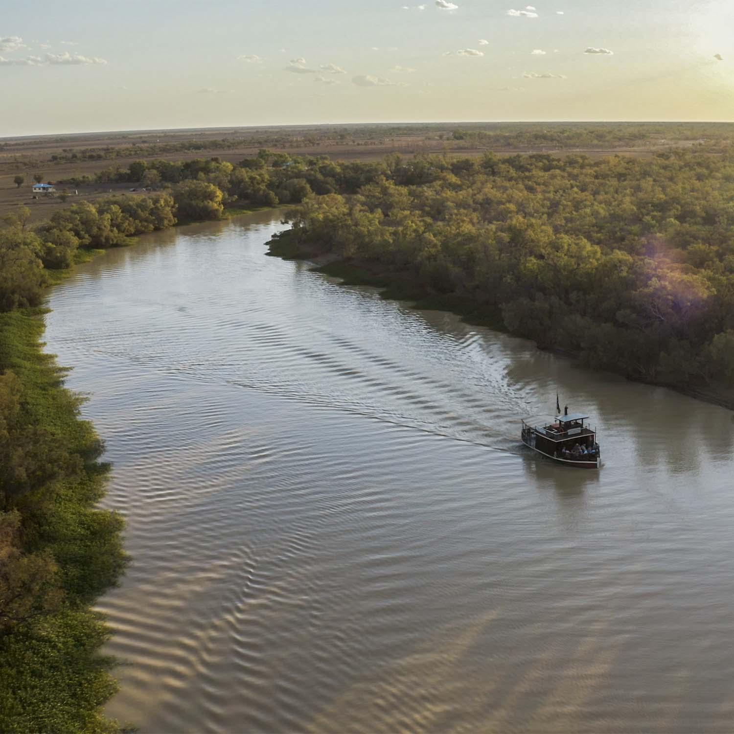 A wide aerial shot of a paddlewheeler cruising along the Thomson River