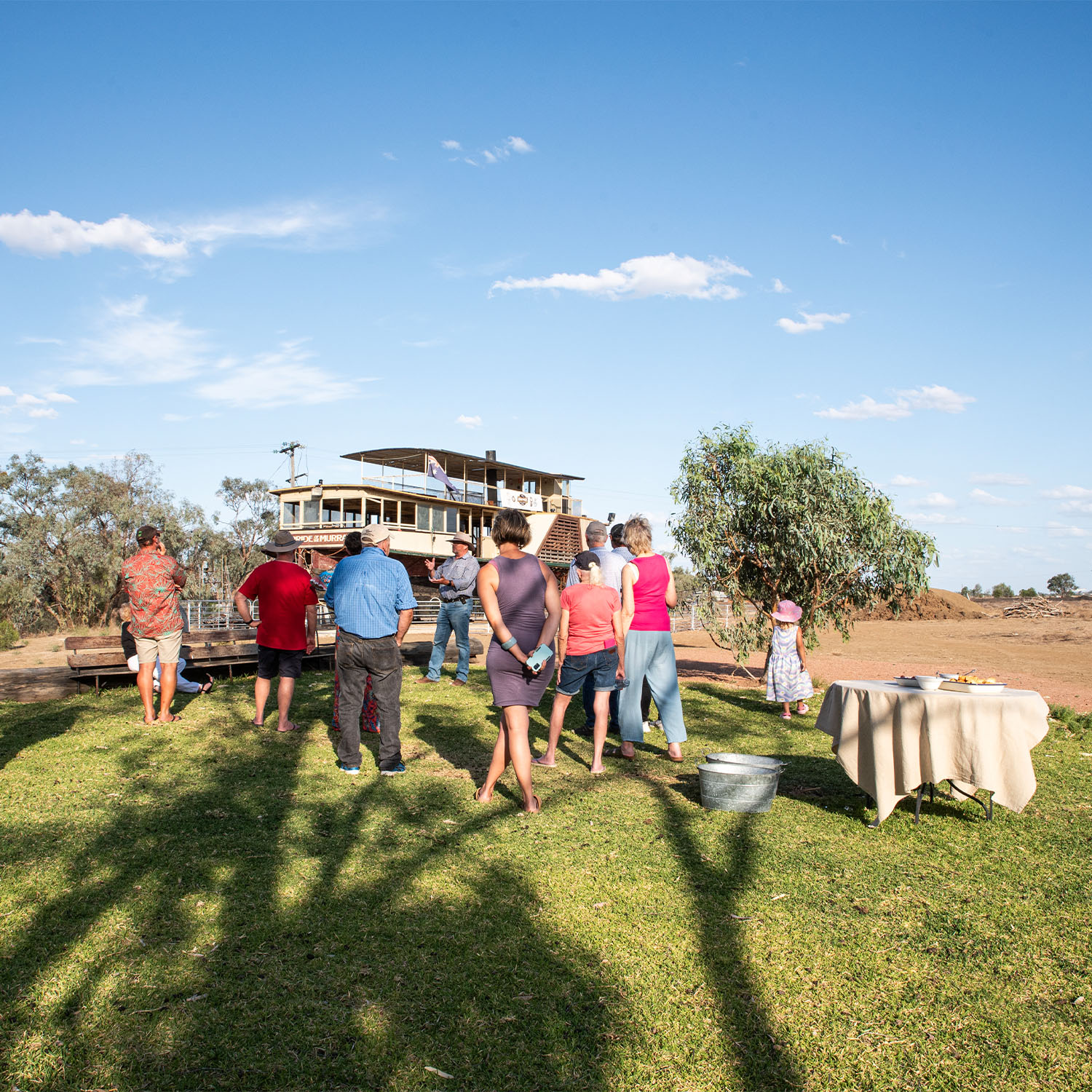 Outback Pioneers host talking to a group of people in front of the Pride of the Murray